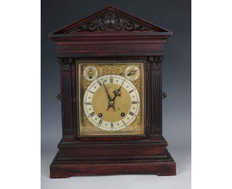 A late 19th century German oak mantel clock with eight day movement striking on two gongs, the backplate stamped 'W &amp; H S