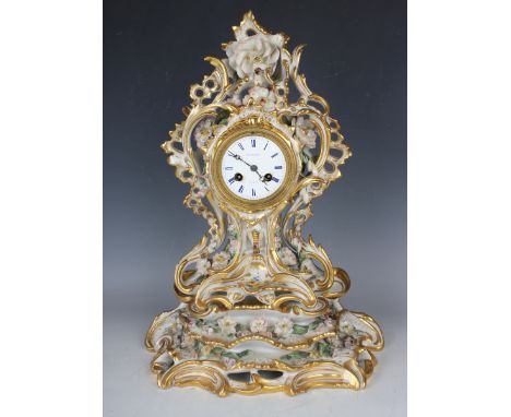 A mid-19th century French Paris porcelain mantel clock and stand with eight day movement striking on a bell via an outside co