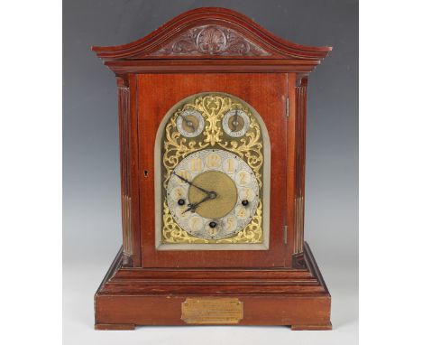 An early 20th century mahogany bracket clock with three train eight day movement chiming quarters on four gongs and striking 