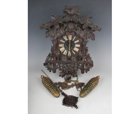 A late 19th century Black Forest carved oak cuckoo wall clock by Fürderer Jaegler, the weight driven movement with wooden pla