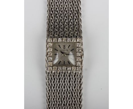 A Corum 18ct white gold and diamond lady's bracelet wristwatch, the signed square silvered dial with black baton hour markers