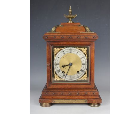 A late 19th century German brass mounted walnut mantel clock with eight day movement striking quarters on a gong, the backpla