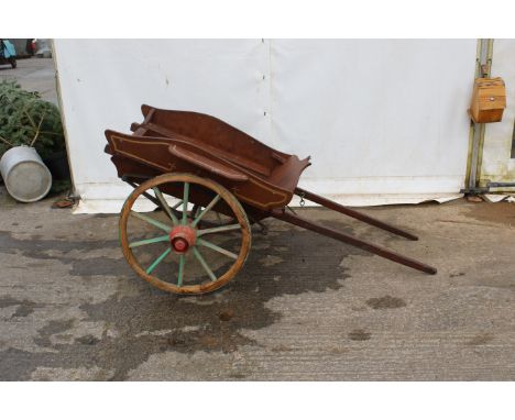 A vintage Wooden hand cart. With a wooden frame on an iron chassis with cast iron wheels, originally used for carnivals, comp