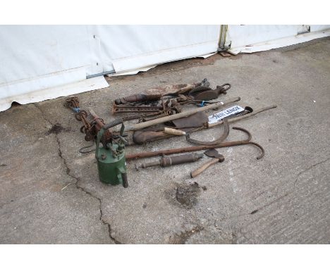 An assortment of vintage farming tools and bygones. Including cart brake, branding irons, yoke, shepherds crook, etc.