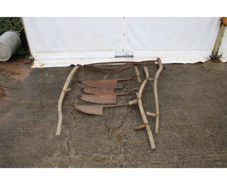 A collection of vintage grassland tools. Including scythes and hay knives etc.