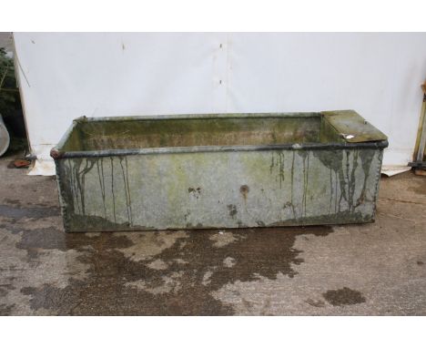 A galvanised riveted drinking trough. Complete with a plumbing box, H56cm x W186cm x D64cm. 