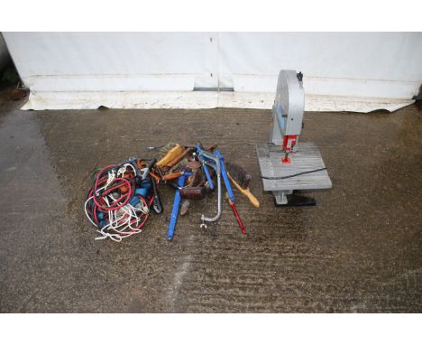 An electric bench saw and an assortment of tools. Noting jump leads, wrenches and brushes etc. 