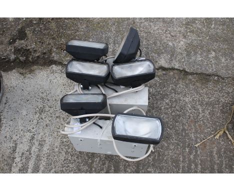 Three sets of two security work lamps lighting boxes. 240v