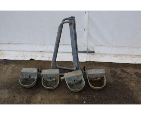A collection of four metal autodrinkers and a swingover gate latch. All drinkers cast metal, H15cm. 
