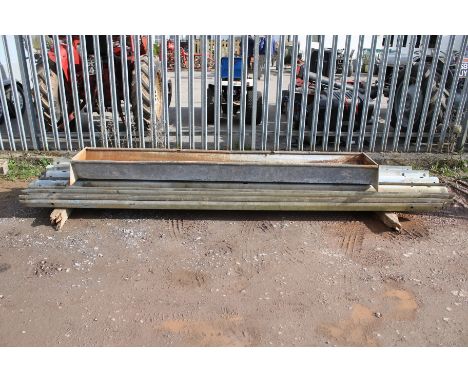 A galvanised metal feeder trough and a quanitity of corrigated&nbsp;motorway crash barriers