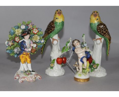 A pair of ceramic parrots, a boy holding a bird and a pastoral figure with basket (4)