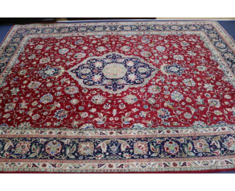 A Tabriz red ground carpet, 340 x 250cm