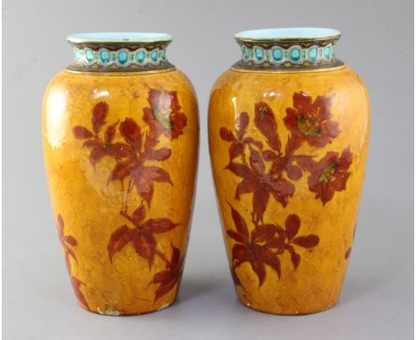 A pair of French Art pottery ovoid vases, by Optat Milet, Sevres, c.1890, decorated with brown flowers on a moulded ochre gro