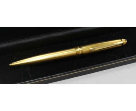 A yellow metal Mont Blanc Meisterstuck ballpoint pen.