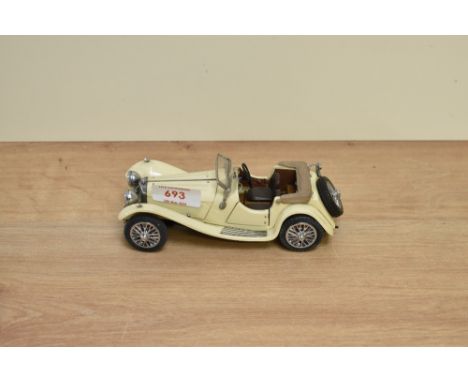 A 1986 Franklin Mint 1:24 scale Die-cast, 1938 Jaguar SS-100 having loose wheel, tag and certificate, in card box with polyst