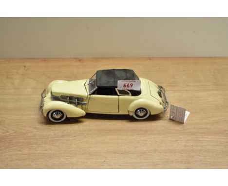 A 1989 Franklin Mint 1:24 scale Die-cast, 1937 Cord 812 Phaeton Coupe with tag and certificates, in card box with polystyrene