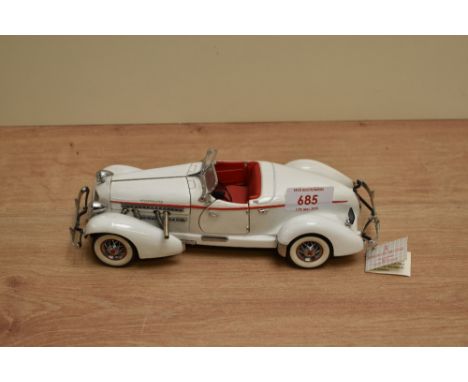 A 1990 Franklin Mint 1:24 scale Die-cast, 1935 Auburn 851 Speedster with tag and certificates, in card box with polystyrene c