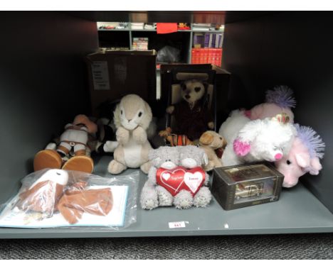 A collection of modern collectable and Souvenir Bears including Mickey Mouse, Meerkat, Glove Puppet, Camels etc along with a 