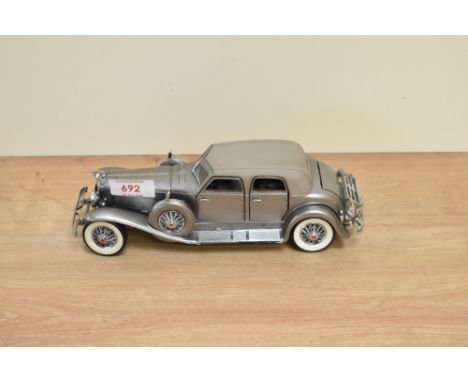 A 1989 Franklin Mint 1:24 scale Die-cast, 1933 Duesenberg SJ Twenty Grandwith tag and certificates, with polystyrene cradle