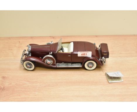 A Franklin Mint 1:24 scale Die-cast, 1935 Duesenberg J550 with tag and certificates, in card box with polystyrene cradle