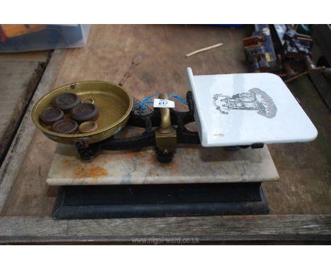 A pair of dairy scales and a collection of weights.