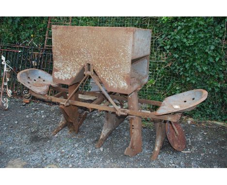 A Ferguson potato seed Planter and hopper having two metal seats for the on-board potato seed feeding operatives. 