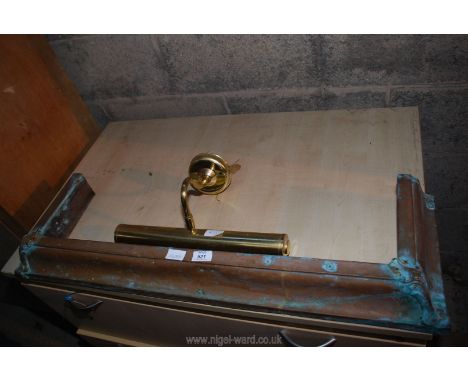 A copper fire curb and a brass picture light.