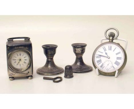 Silver cased miniature carriage clock, two squat silver candlestick, Goliath watch and a thimble. Condition report: see terms