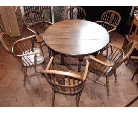 Reproduction oak bobbin-turned gate-leg dining table and six Windsor style elbow chairs. Condition report: see terms and cond