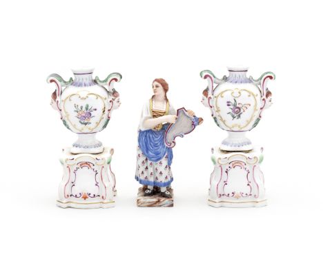 A pair of Doccia miniature vases on pedestals and a small Doccia figure of a girl, circa 1790-1800Each vase modelled with two