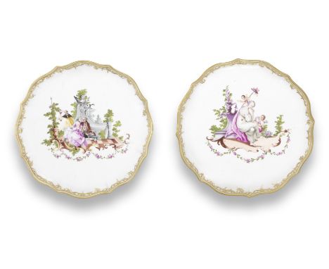 A pair of Vienna circular présentoirs, circa 1755Each painted with a rococo scene on a scrollwork base hung with flower swags
