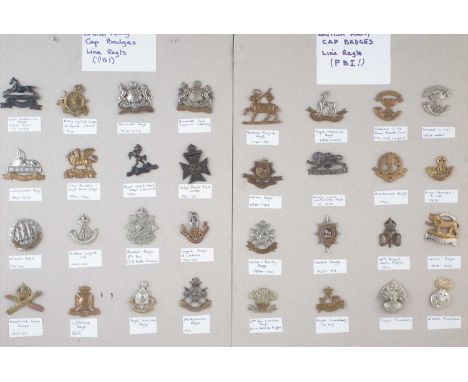 Thirty two British Army cap badges, mainly line regiments, mounted on card.
