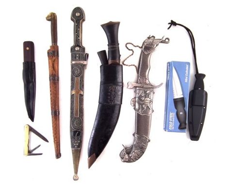 Collection of knives, to include a North African Flyssa and carved wood scabbard, a Kukri with its two small knives in scabba