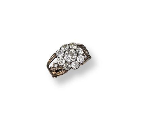 A George III diamond cluster ring, the cushion shaped diamonds are set in silver and gold, pierced gold shank. Size M.