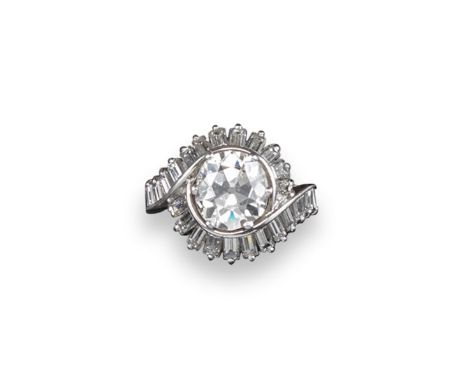 A diamond cluster ring, the old circular-cut diamond weighs approximately 2.90cts and is set within a surround of scrolling b