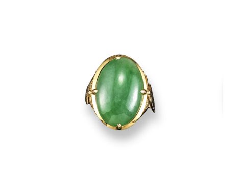 A jade mounted gold ring, the oval-shaped jade cabochon is set in gold with foliate shoulders. Size I. Accompanied by report 