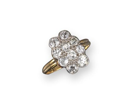 A diamond cluster ring, set with ten circular cut diamonds in platinum and gold. Size K 1/2.