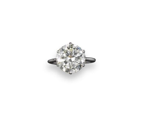 A circular cut diamond solitaire ring, the diamond weighs approximately 5.10cts. Set in platinum. Size M. Box by Ogden.