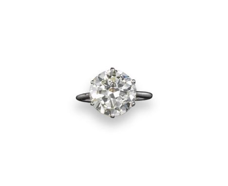 A circular cut diamond solitaire ring, the diamond weighs approximately 5.10cts. Set in platinum. Size M. Box by Ogden.