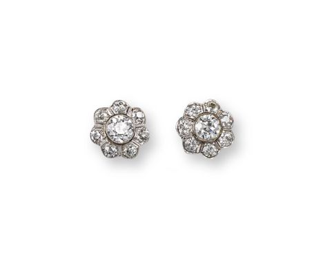 A pair of diamond cluster earrings, the central old circular-cut diamonds weigh approximately 0.65cts each and are millegrain