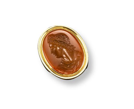 A 19th century carved carnelian intaglio mounted gold ring, depicting the profile of a man wearing a headband and wearing a c