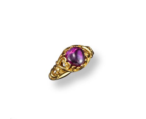 A Victorian cabochon ruby mounted gold ring, pierced scroll shank. Size L. Cased
