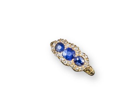 A Victorian triple sapphire and diamond cluster ring, set in gold with scroll carved shoulders, Birmingham marks for 1895. Si