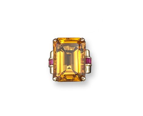 A citrine and ruby mounted gold ring, the emerald cut citrine is set with six baguette-shaped shoulder rubies in gold. Size O