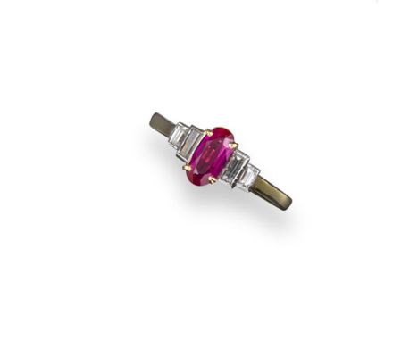 A Burmese ruby and diamond half hoop ring, the oval-shaped ruby is set with four baguette-shaped diamonds in 18ct gold size M