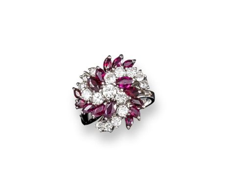 A ruby and diamond swirl cluster ring, set with graduated round brilliant-cut diamonds and marquise-shaped rubies in white go