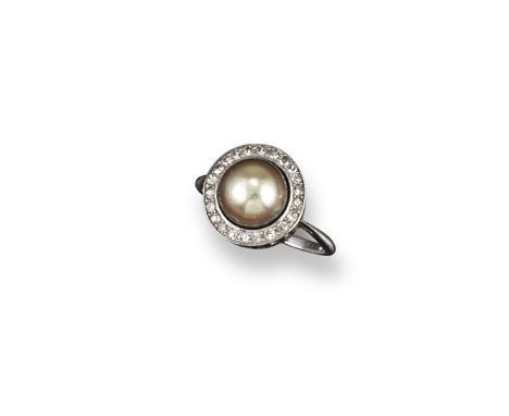 A pearl and diamond cluster ring, the natural pearl is set within a circular surround of single-cut diamonds in platinum. Siz