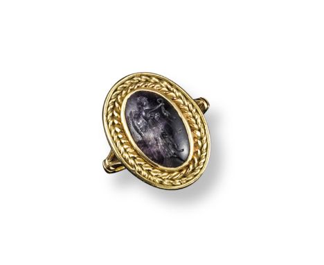 A carved hardstone cameo mounted ring, depicting the profile of a woman, her hair tied up, gold mount, damaged. Probably earl