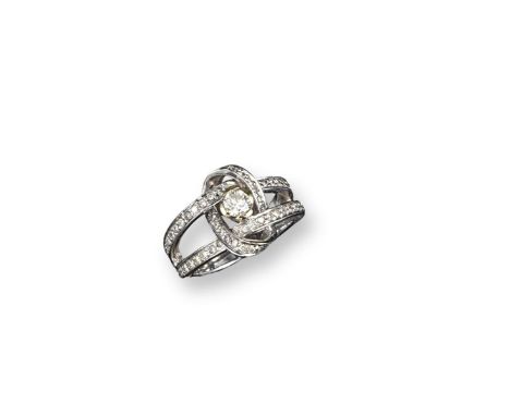 A diamond-set scroll ring, set with graduated circular-cut diamonds in white gold. Size N.