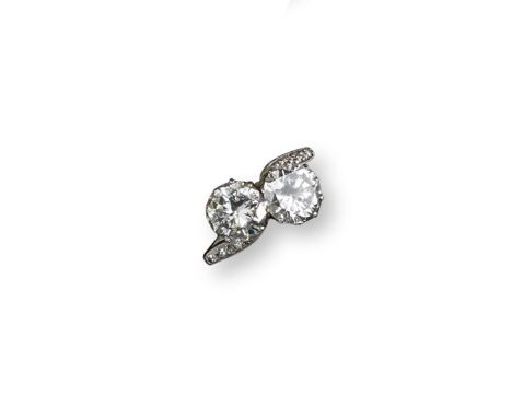 A two stone diamond cross-over ring, the round brilliant-cut diamonds weigh approximately 3.20cts in total and are set in whi